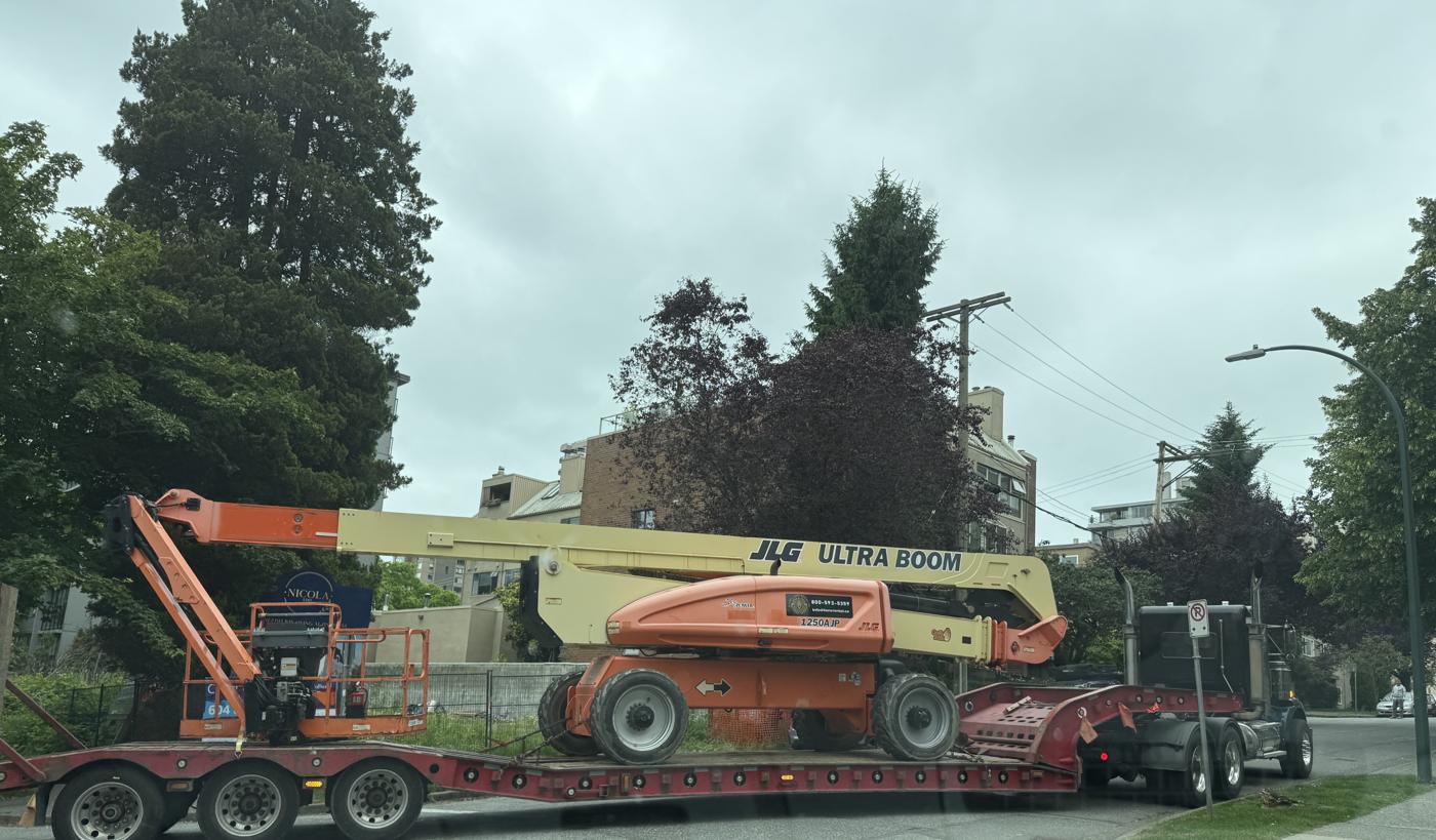 Boom lift on a lowbed trailer on the way to site